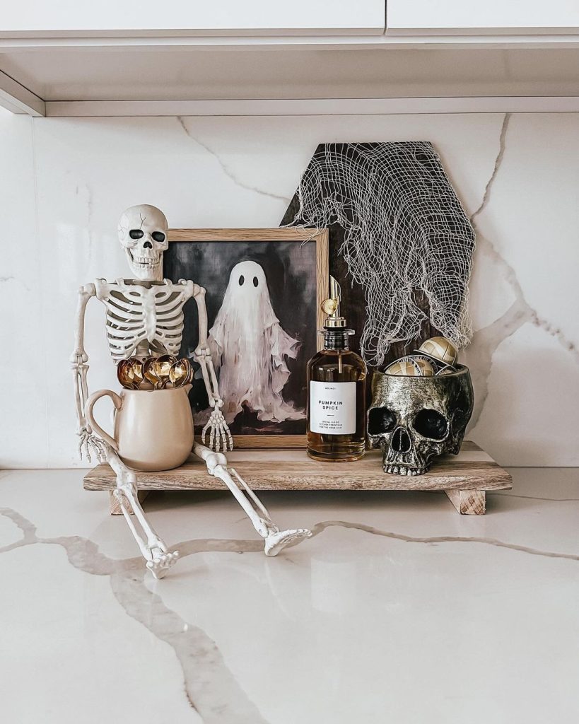 Kitchen counter Halloween display with skeleton ghost artwork marble surfaces