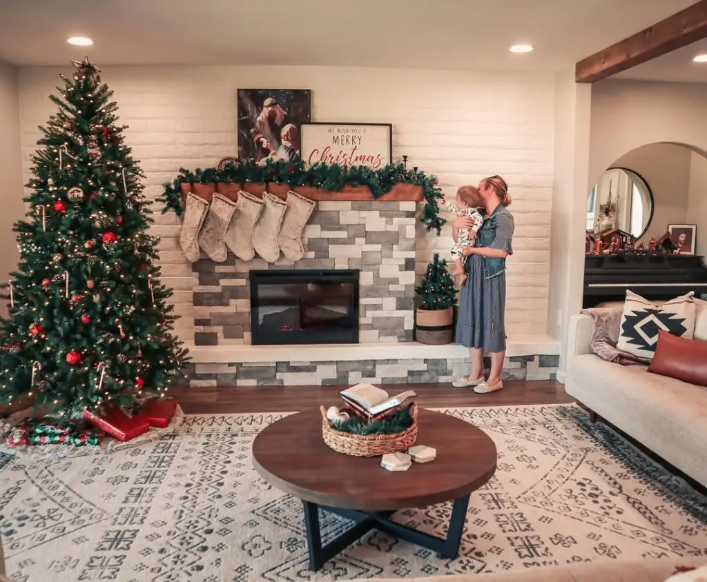 Family decorating Christmas fireplace together living room