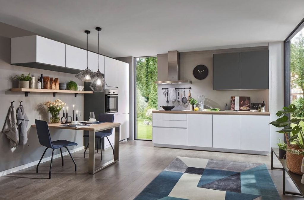 Clean white kitchen with wood accents and colorful geometric rug