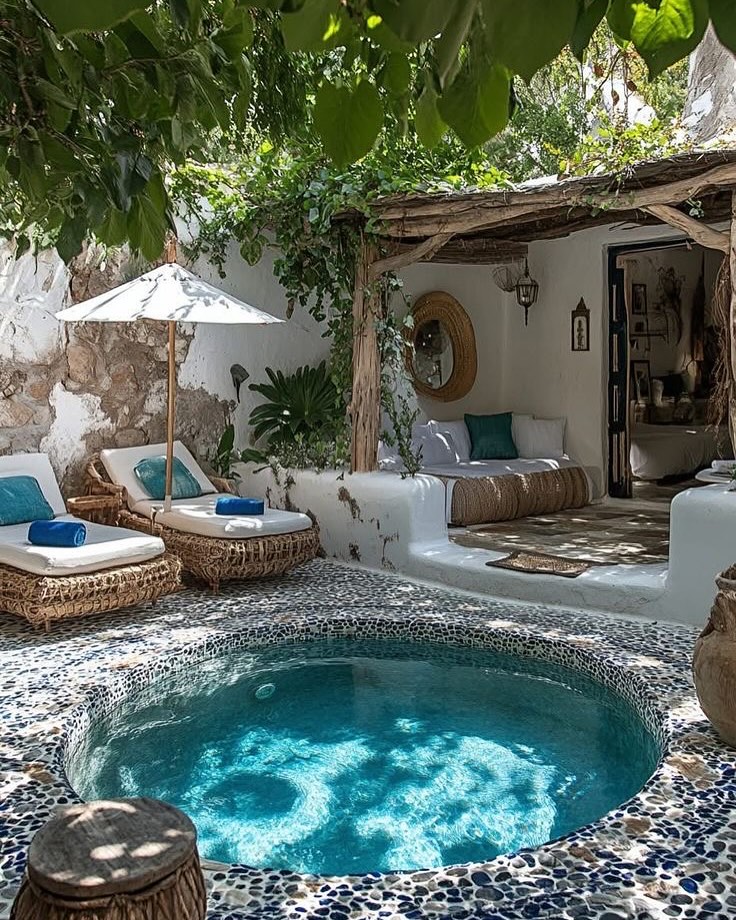 Round Mediterranean pool with mosaic tiles and rustic courtyard design