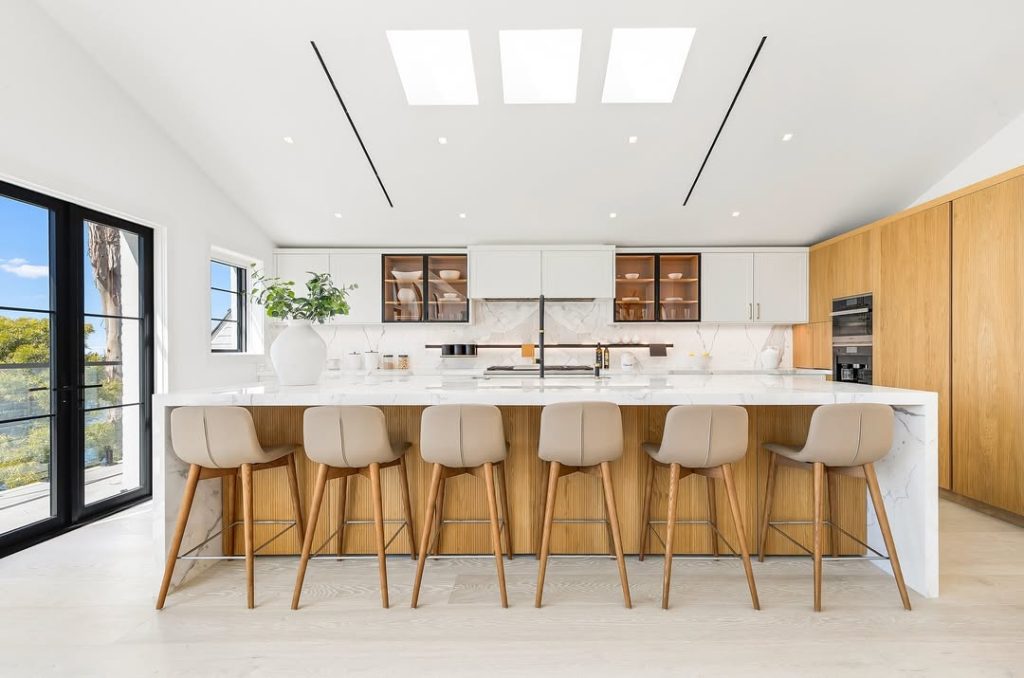 Bright kitchen with wood cabinets and large breakfast bar