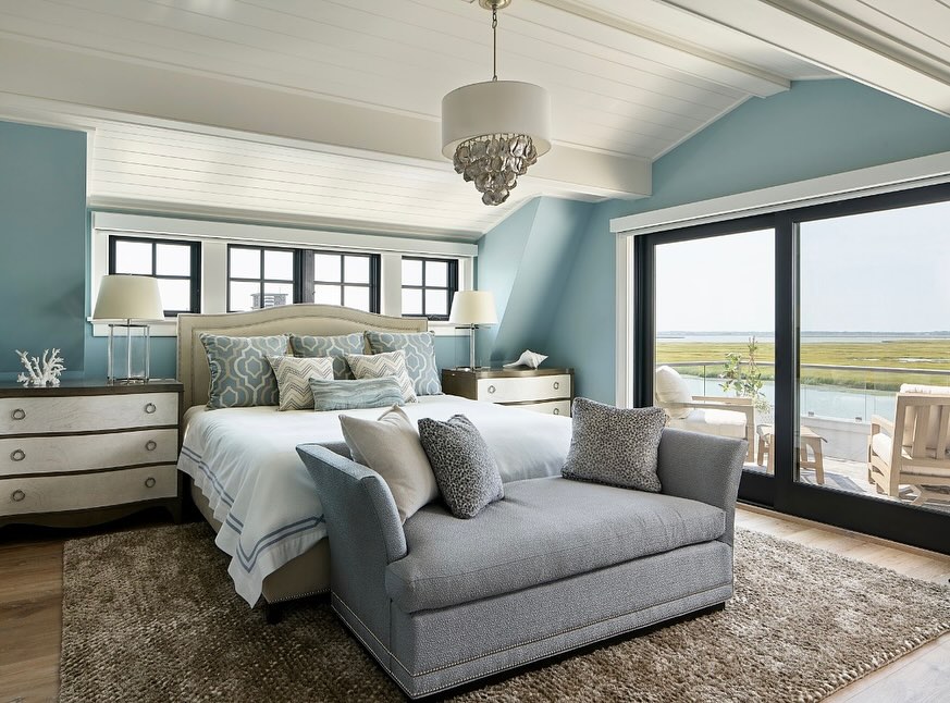 Large blue bedroom with ocean views and built-in seating