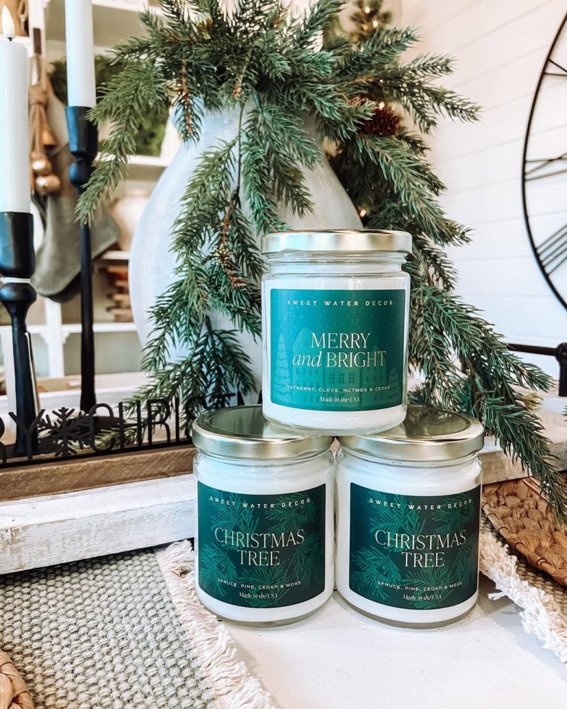 Christmas scented candles arranged with evergreen branches
