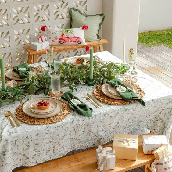 Outdoor holiday table with green linens and natural garden decorations