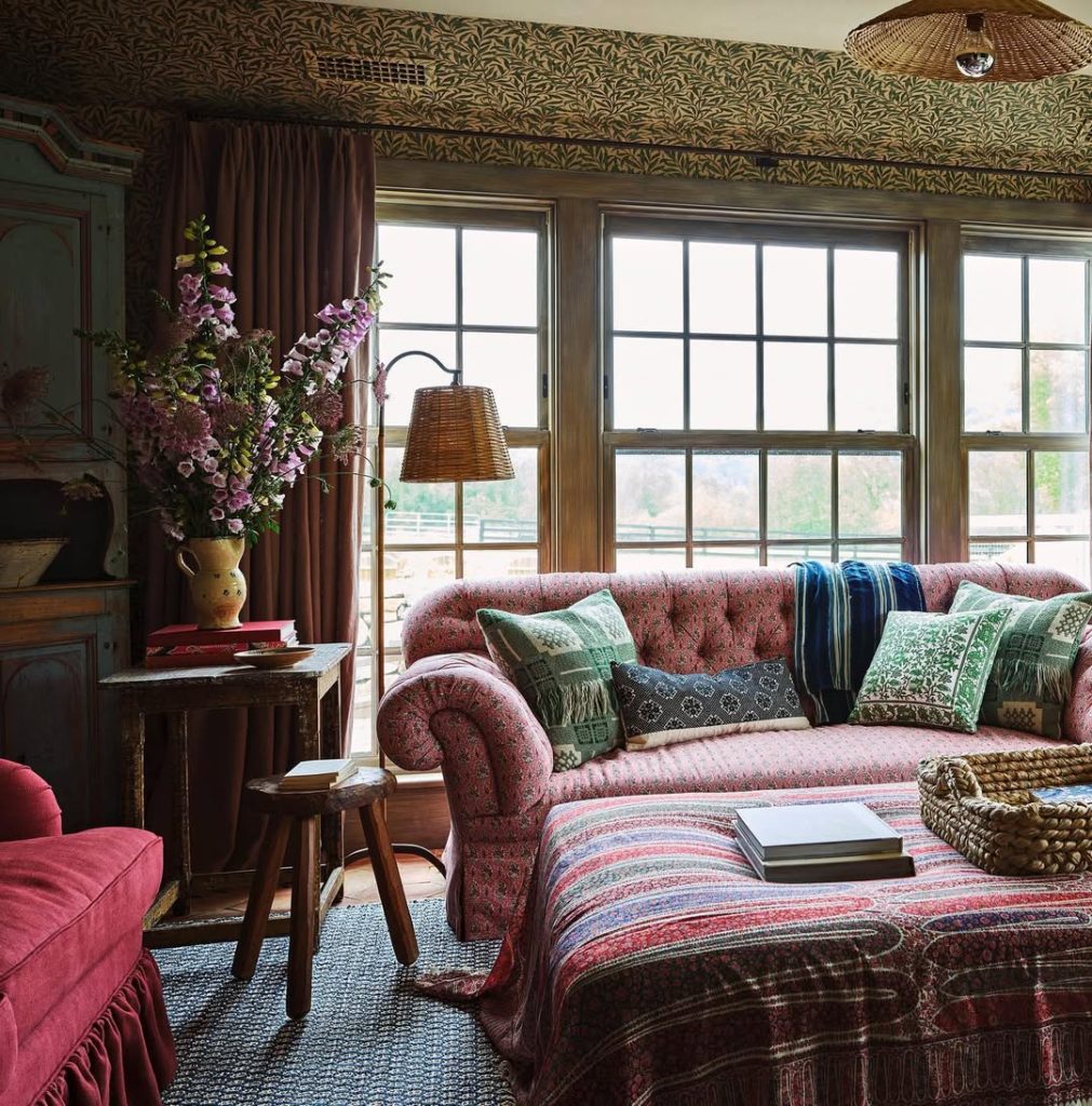 Pink themed living room with twin sofas and fireplace