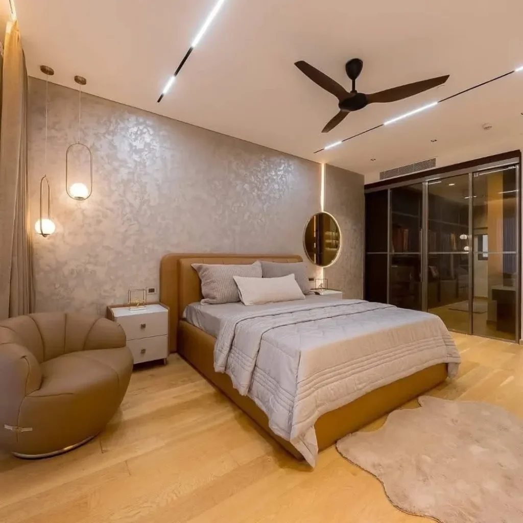 Minimalist bedroom with glass bathroom and pendant lighting