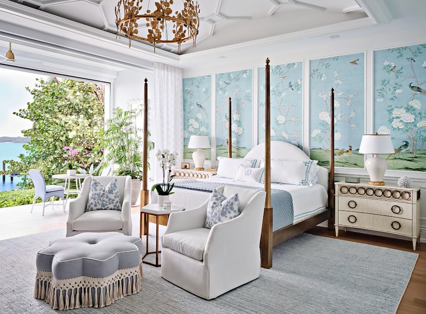 Elegant blue bedroom with floral wallpaper and four-poster bed