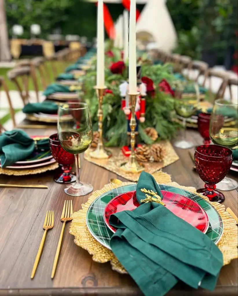 Cozy white holiday table setting with candles and winter decorations