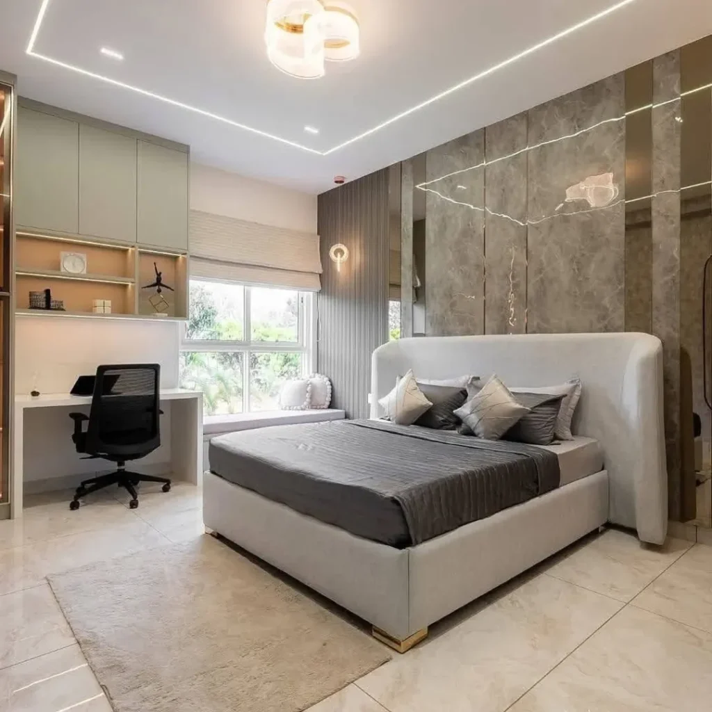 Bedroom with built-in desk and marble accent walls