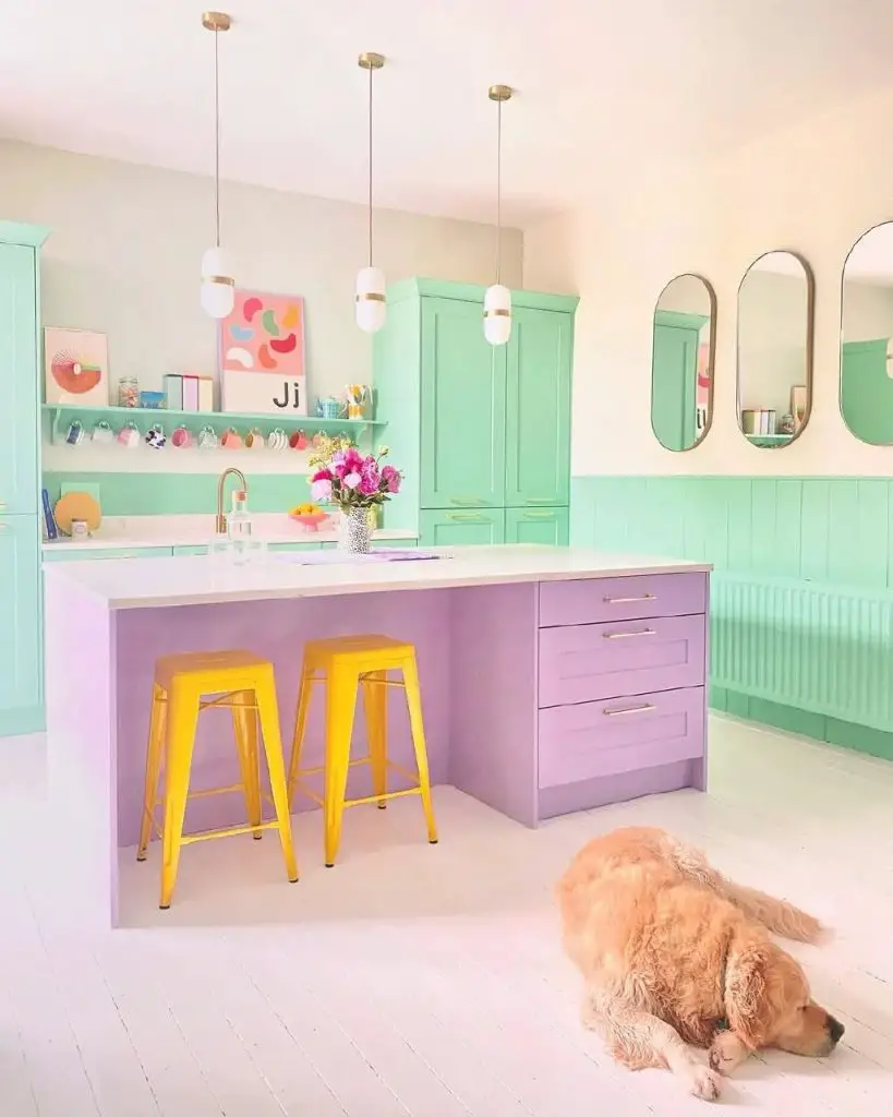 Colorful kitchen with mint green, purple cabinets, and yellow stools
