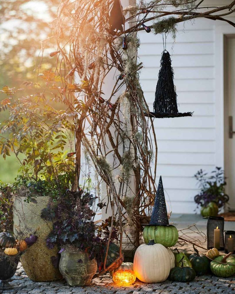 Garden Halloween display with hanging witch Spanish moss twilight pumpkins