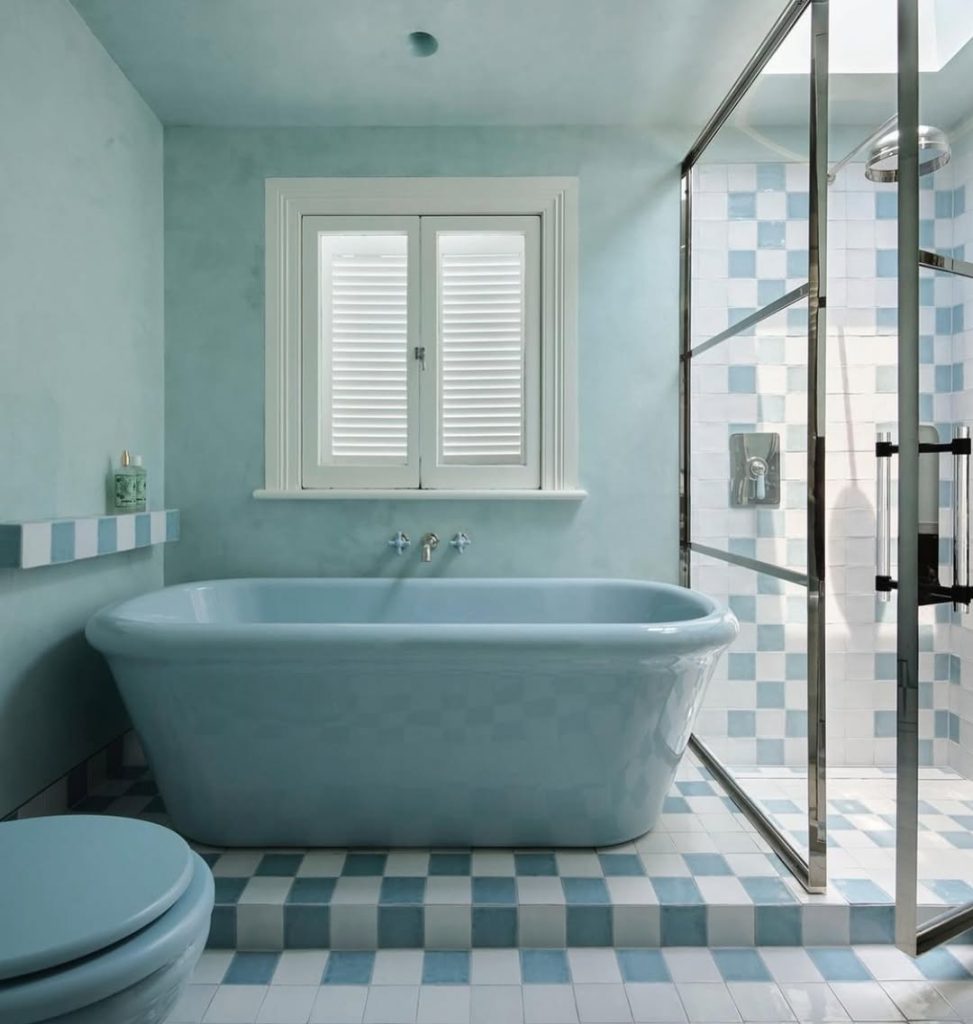 Blue bathroom with freestanding tub and glass shower