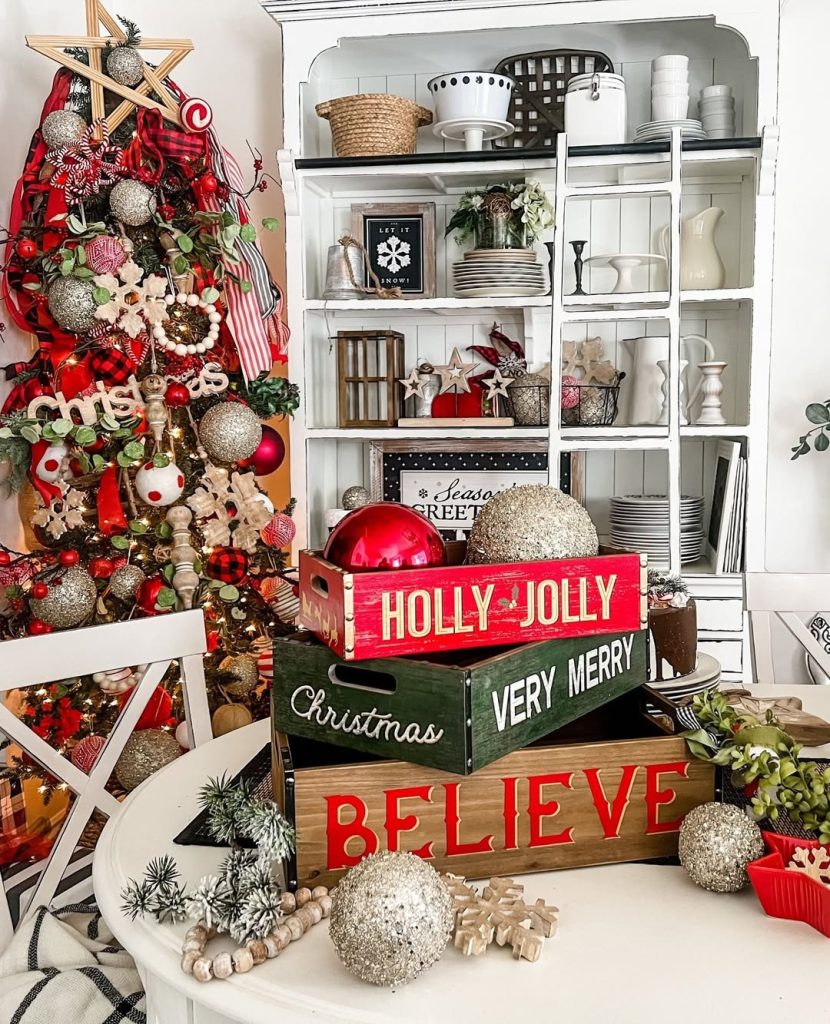 Farmhouse kitchen Christmas display with red ornaments and wooden crates