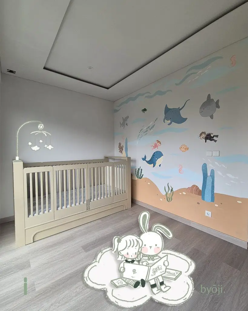 Neutral nursery with realistic whale wall art and ocean theme