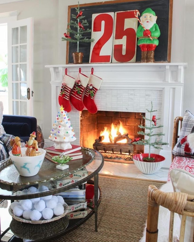 Modern Christmas living room with white fireplace red stockings and natural light