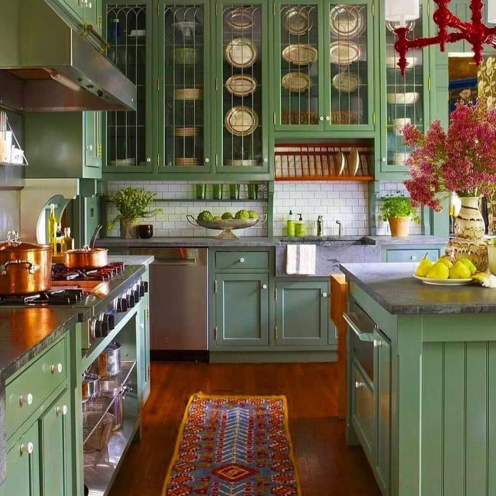 Green kitchen cabinets with copper pots glass doors stone countertops