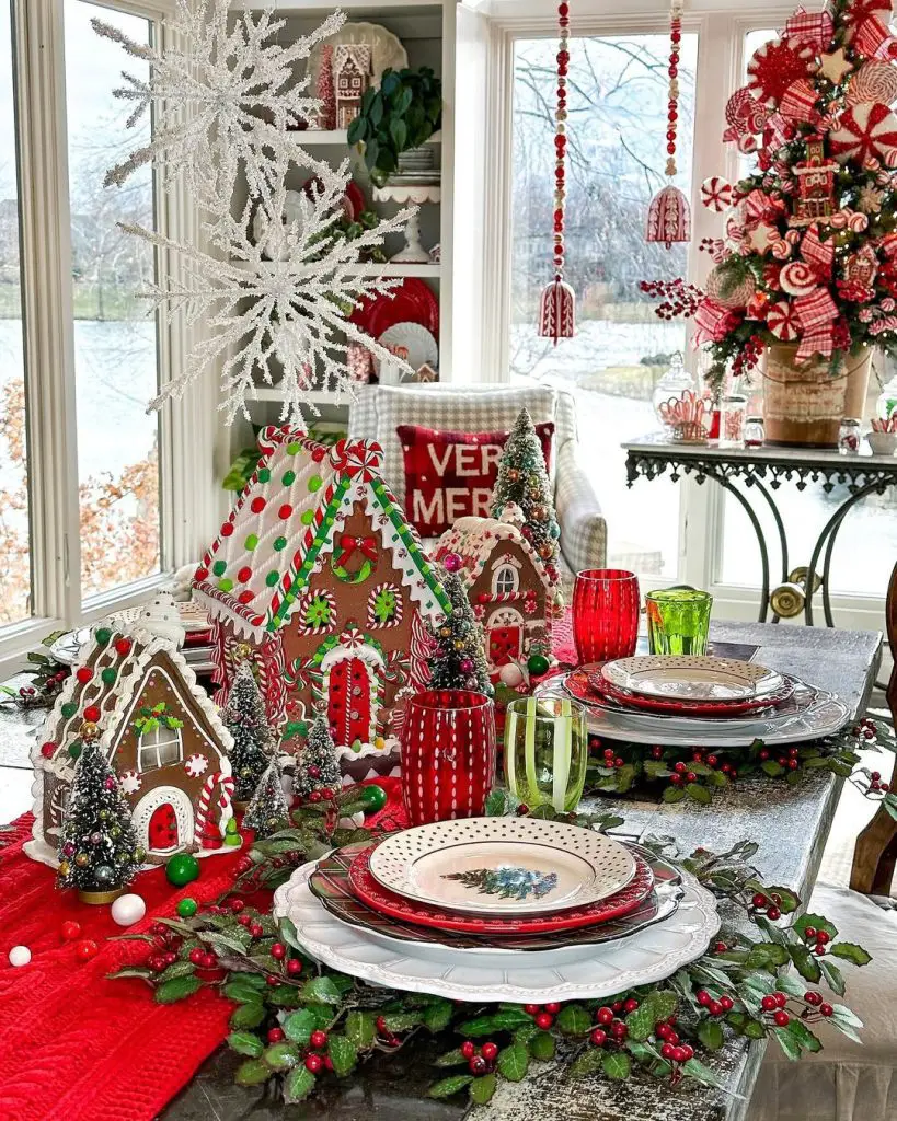 Christmas table with gingerbread houses, snowflake decorations, and colorful holiday setting