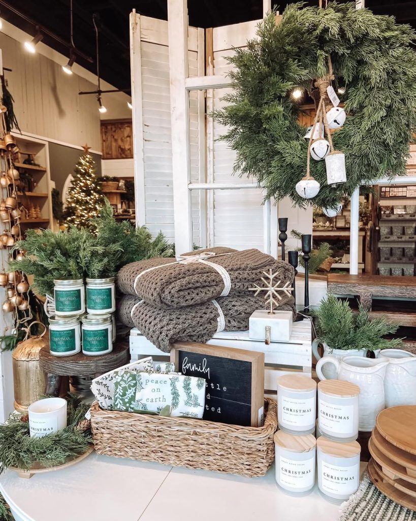 Holiday shop display with shutters wreaths blankets candles