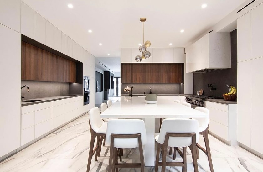  Modern white kitchen with walnut accents and sleek island