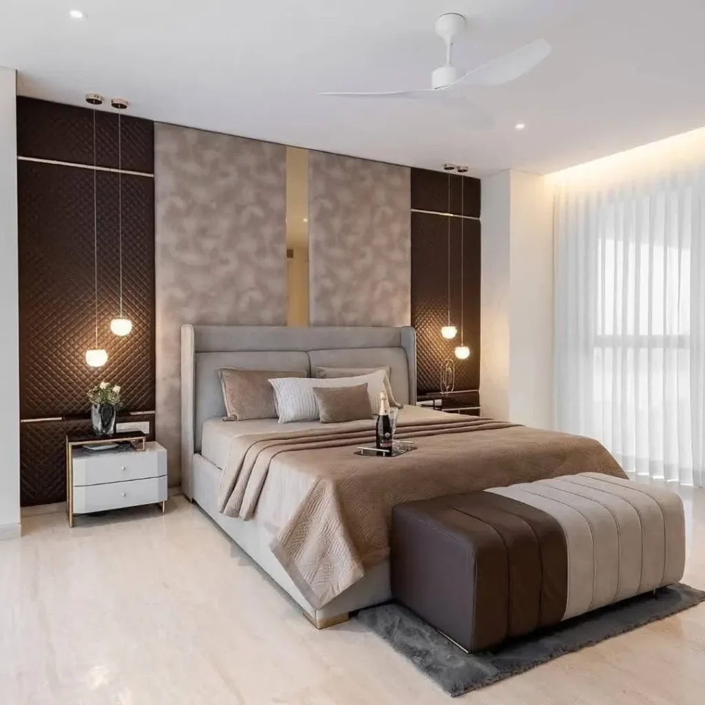 Bedroom with textured accent wall and pendant lighting