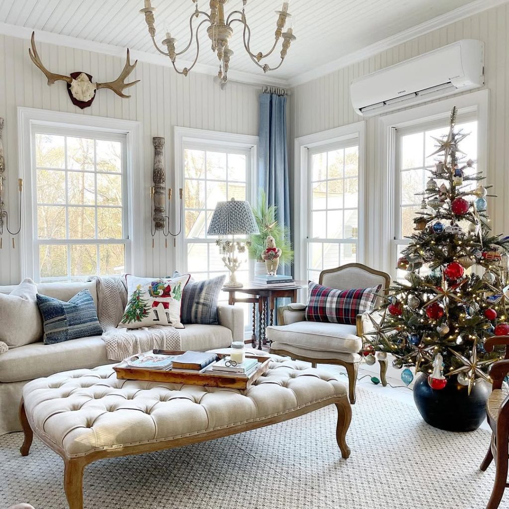 Elegant living room with Christmas tree and plaid accents