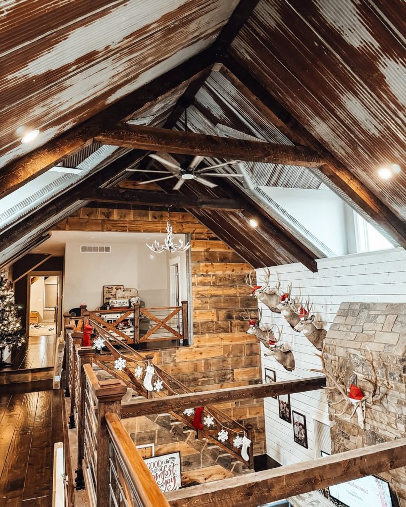 Rustic loft with wooden beams deer mounts and Christmas decorations