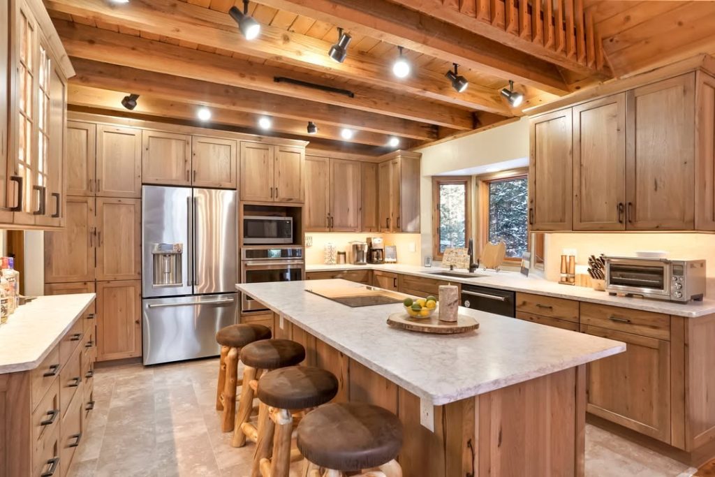 Rustic wood kitchen with exposed beams and marble countertops