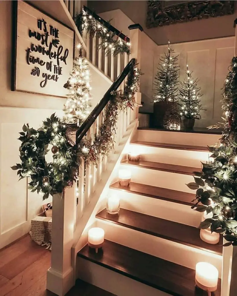 Decorated Christmas staircase with lights and garland display