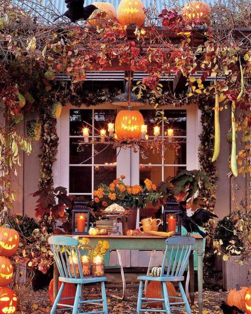 Outdoor Halloween dining setup with carved pumpkins