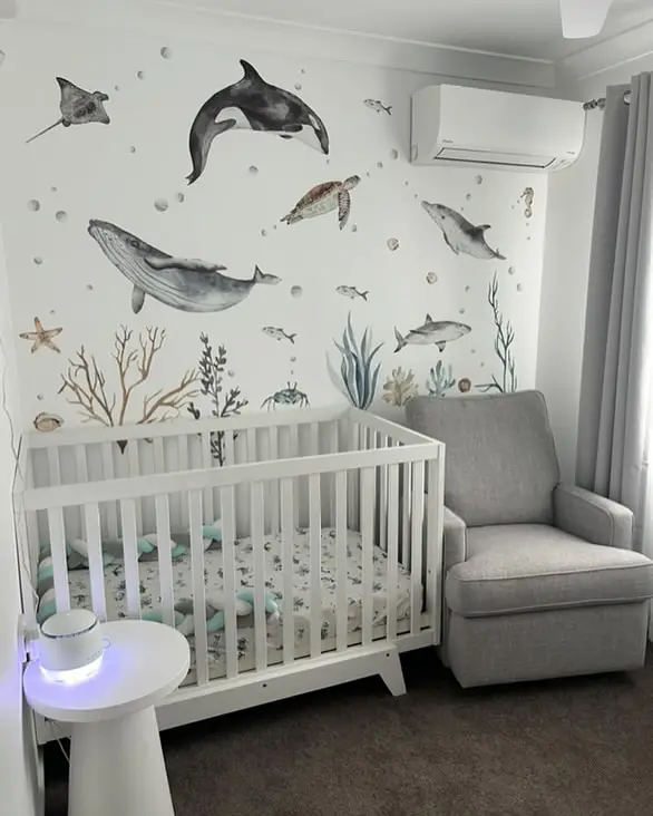 White nursery featuring watercolor marine life wall art