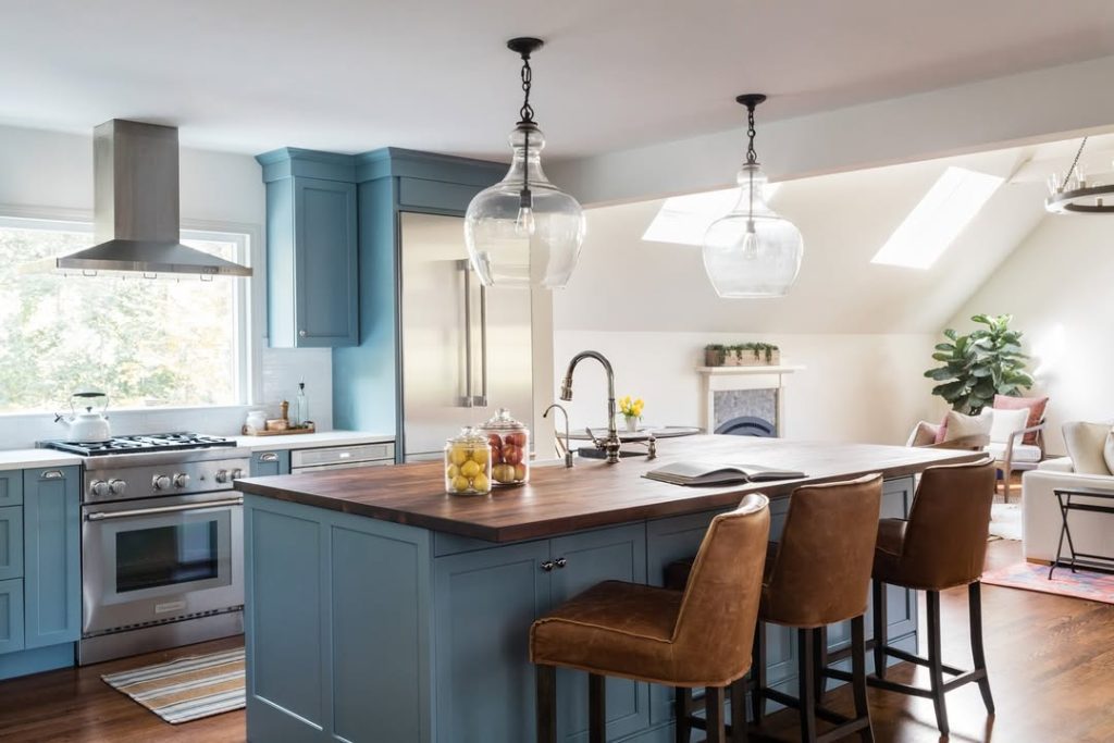 Blue kitchen with walnut island and leather stools