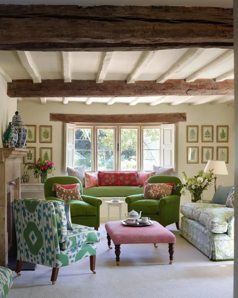 Rustic living room with exposed beams and green chairs
