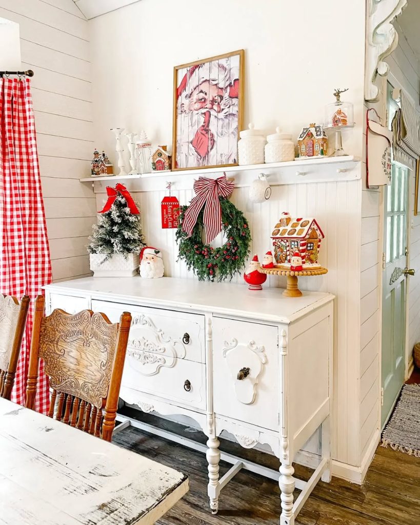 White farmhouse dining room with Christmas sideboard display and gingham curtains