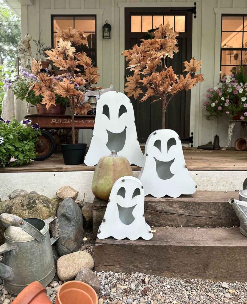 White wooden ghost decorations on farmhouse porch