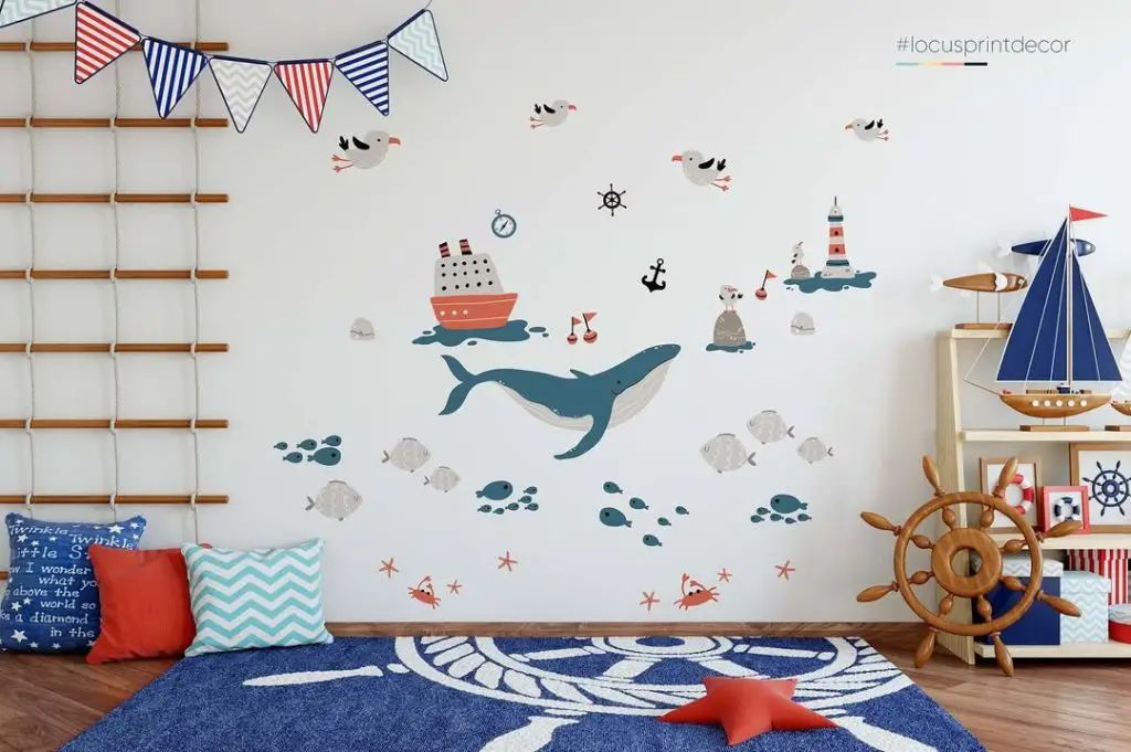 White nursery with nautical bunting and maritime themed wall decals