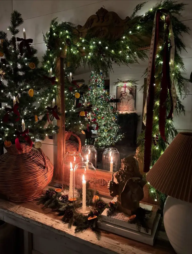 Rustic mantel with Christmas greenery candles and vintage decorations