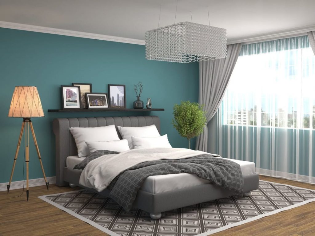 Teal bedroom with crystal chandelier and city views