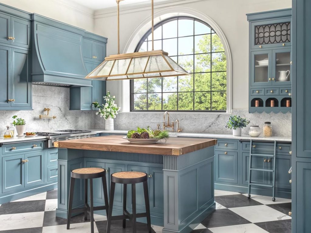 Kitchen with large arched window and blue cabinets