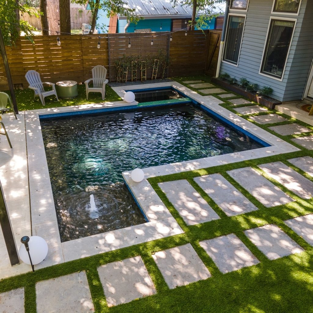 Two-level pool and spa with stone coping and water features