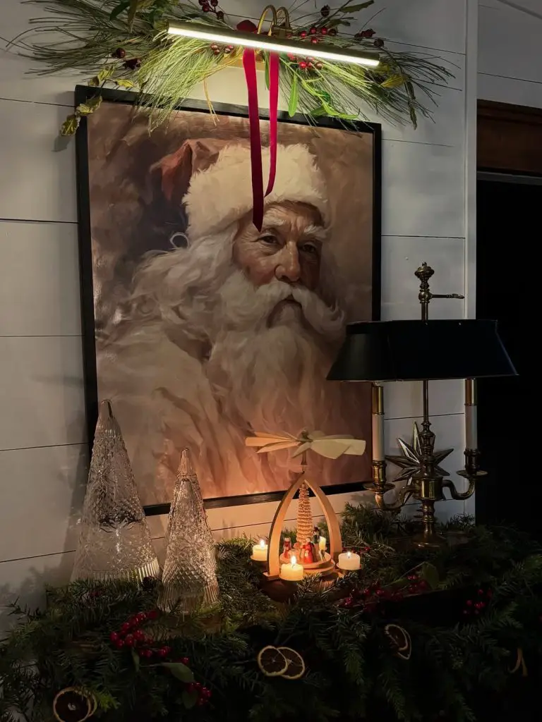 Vintage Santa painting with Christmas decorations and candlelight