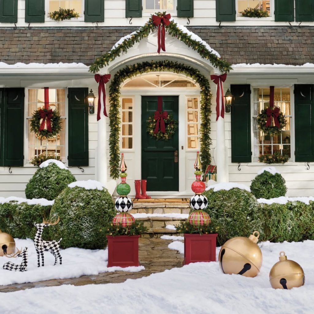 Christmas decorated front porch with garland ribbons and ornamental decorations