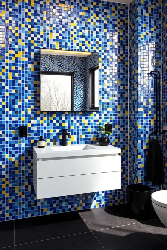 Colorful blue mosaic tile bathroom with white floating vanity