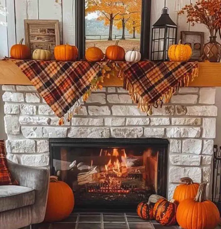 Stone fireplace with plaid runner and autumn pumpkin display creating cozy fall atmosphere