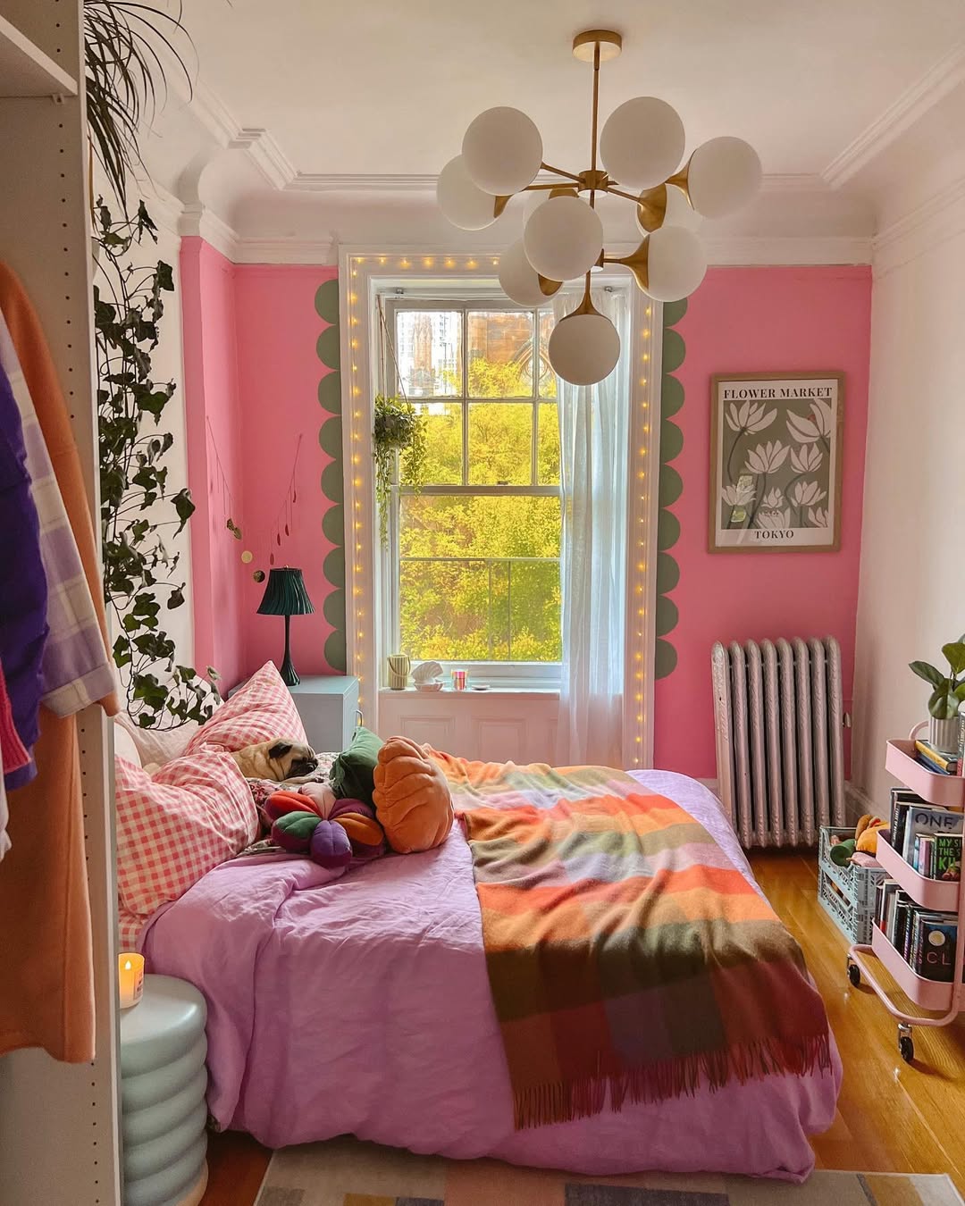 Bright pink bedroom with eclectic decor and plants