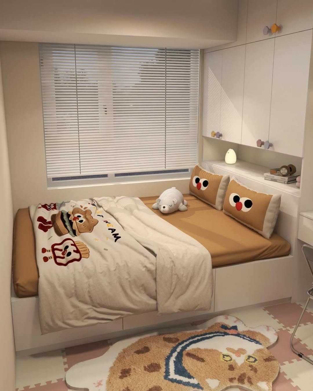Built-in bedroom with cute character pillows and storage