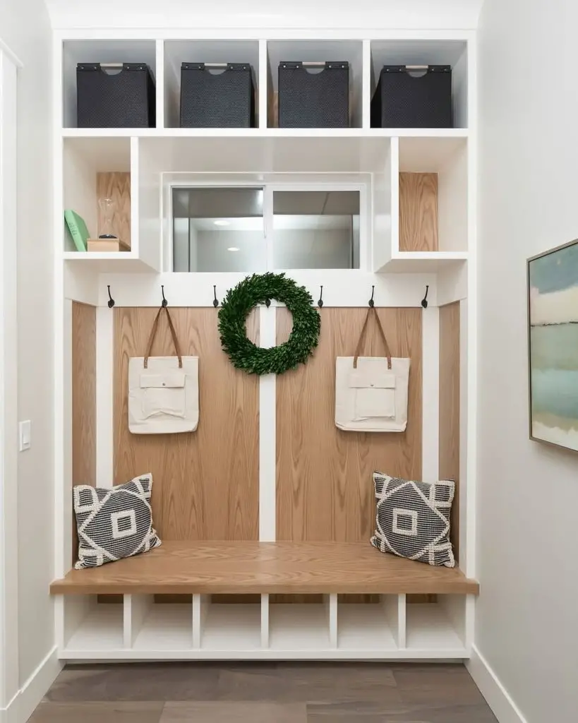 Modern mudroom with wood accents, white storage, and minimalist design