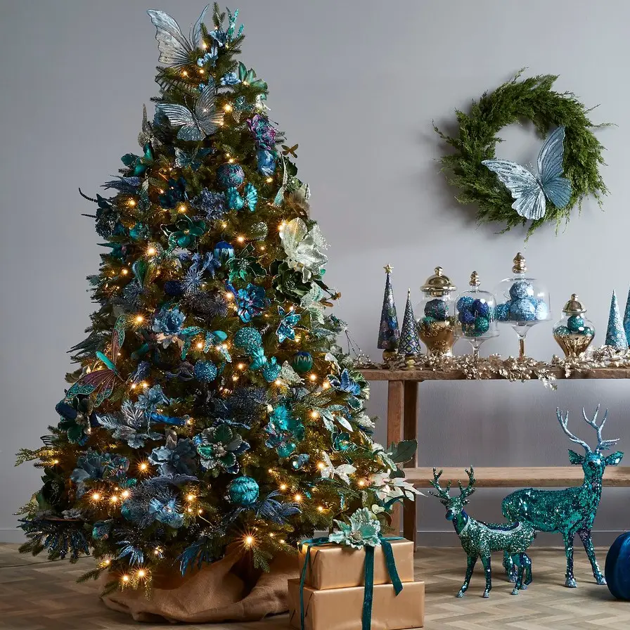 Green Christmas tree with blue butterflies and silver ornaments