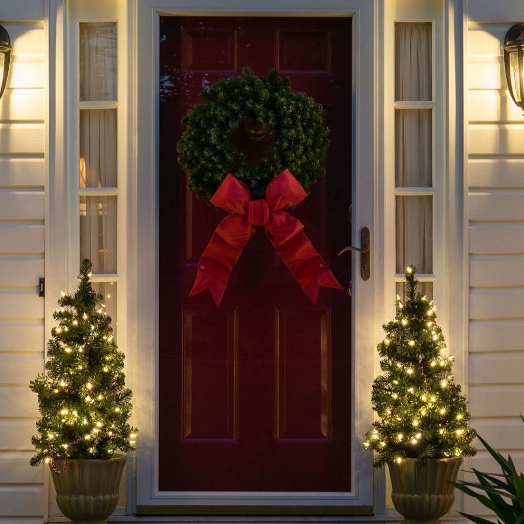  Elegant Christmas door with wreath topiary trees warm lighting