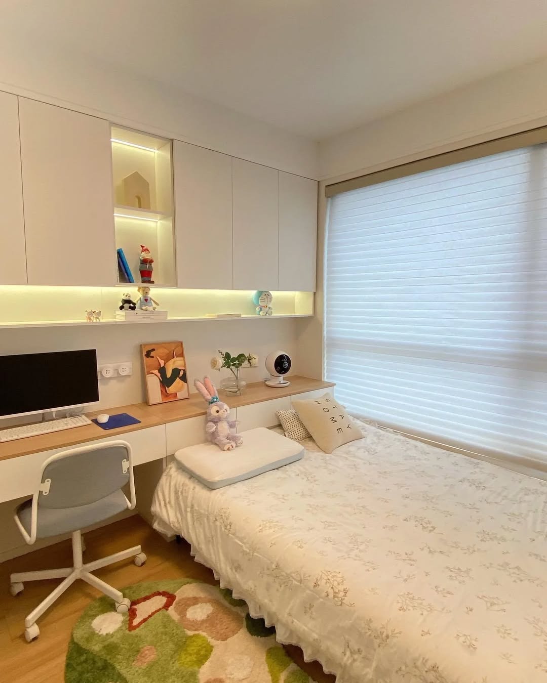 White bedroom with integrated desk and LED lighting