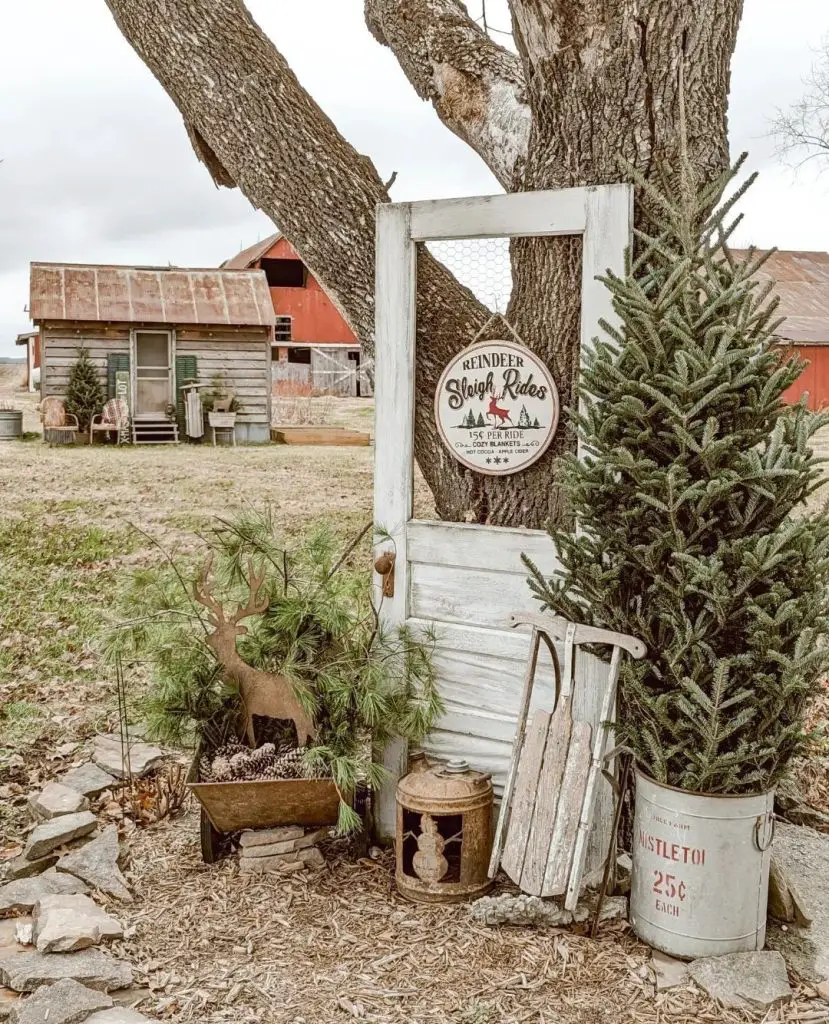 Rustic Christmas farm display with trees reindeer vintage decor